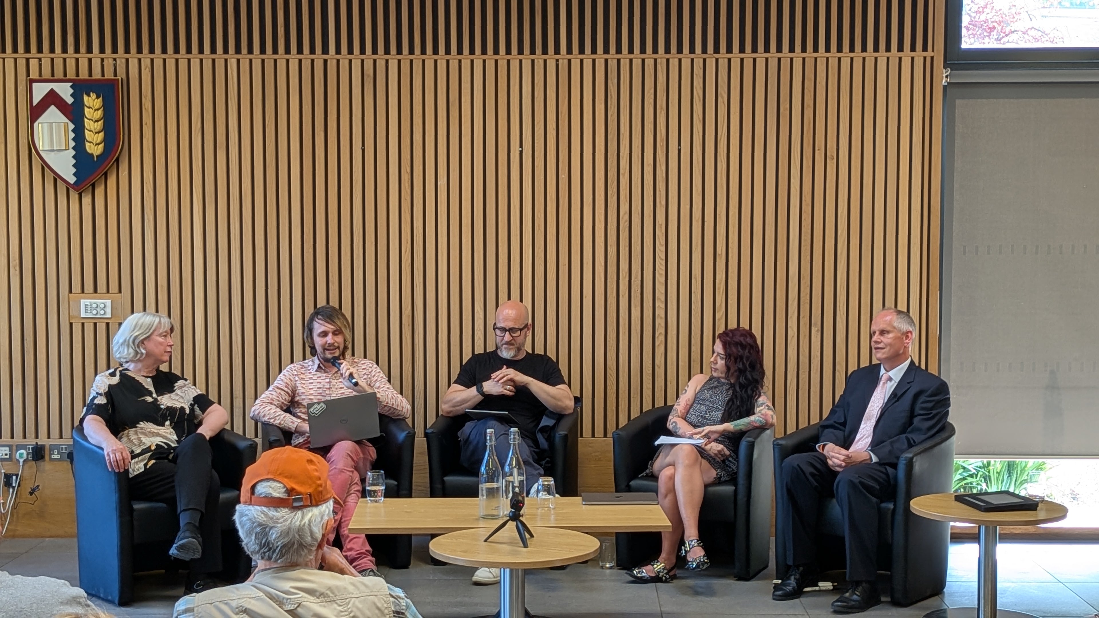 The panel are seated in discussion. Dave Williams is in the far right seat
