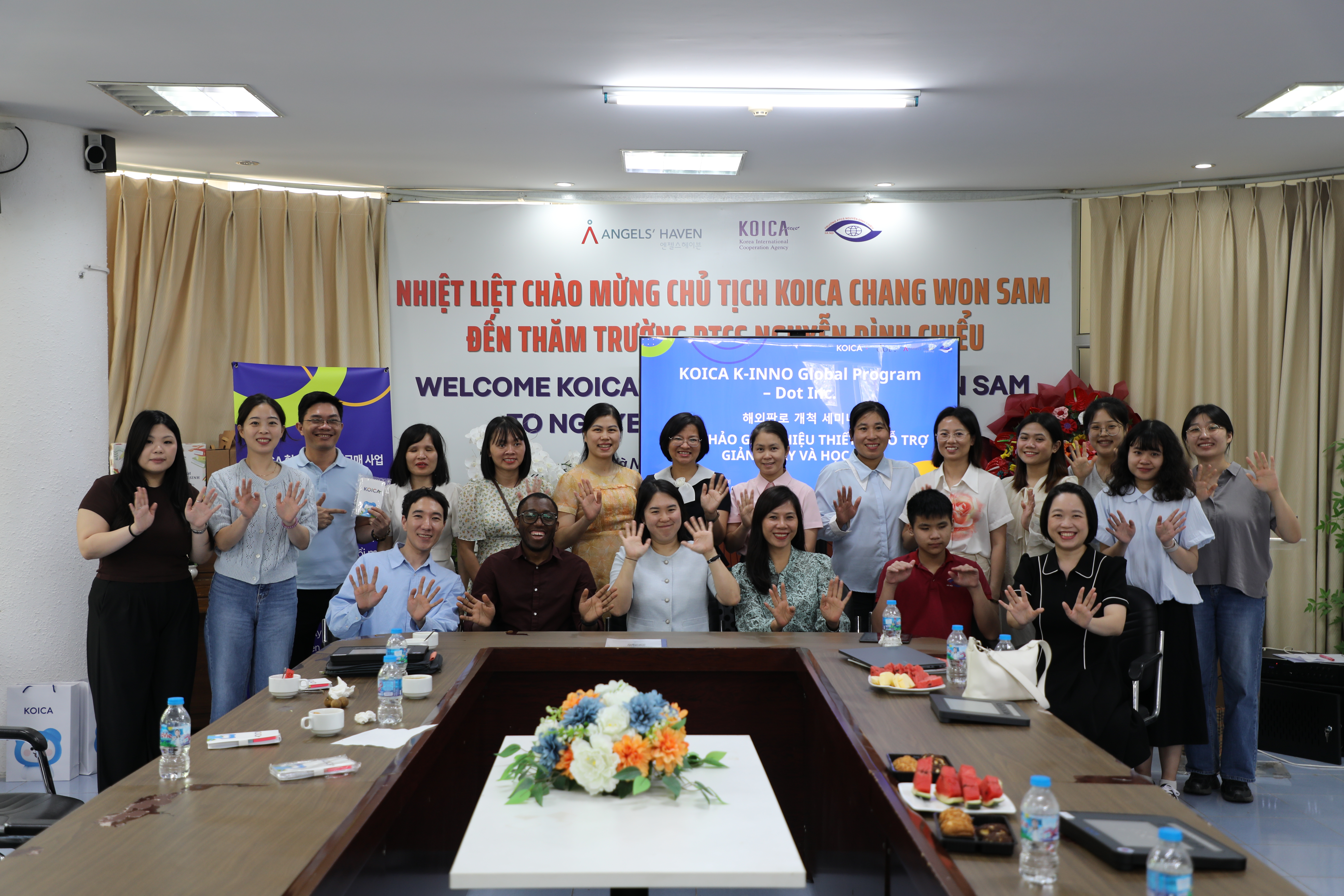A wide, welcoming shot of the team or a school entrance: Vietnam folder (KOICA welcome banner / seminar scene).